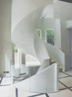Double helical stone and polished plaster stairs with GRG balustrade and soffit