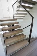 3 flight cantilevered filleto marble stone stairs 
with glass balustrade with patinated bronze
 handrails and also bronze glass connector caps